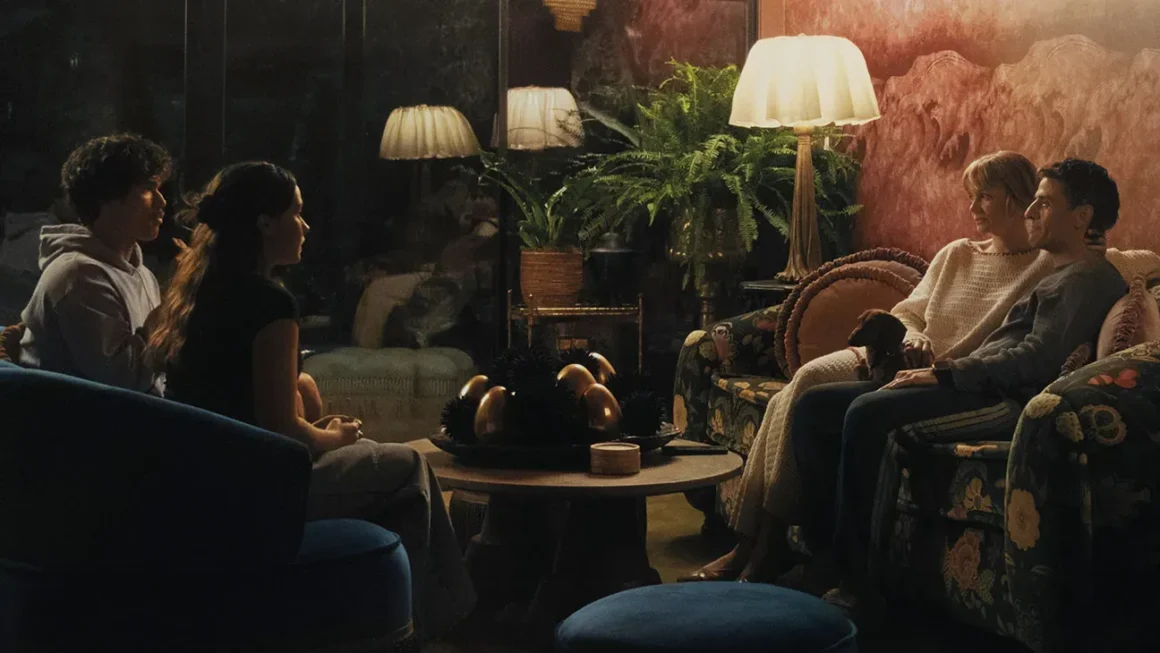 Charles Melton, Cailee Spaeny, Carey Mulligan and Oscar Isaac sitting across from each other in a tense living room scene from Beef Season 2