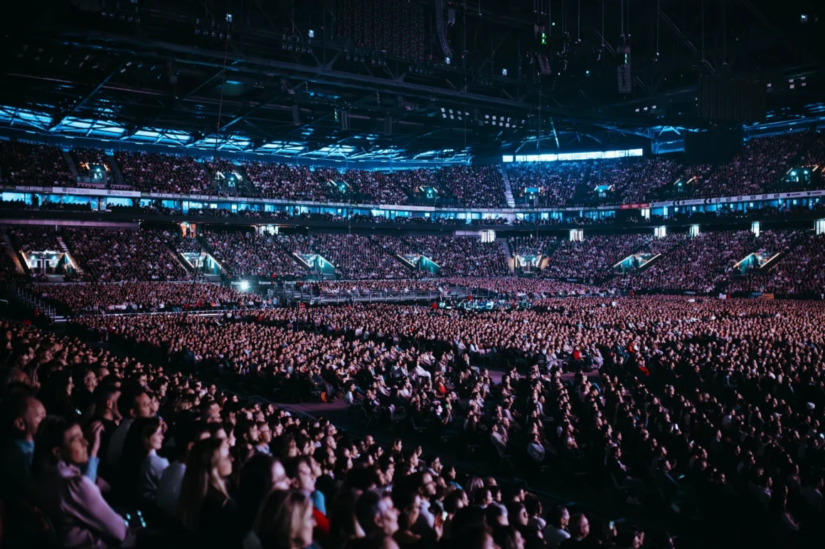 Wide interior view of a packed audience inside Paris La Défense Arena in Paris, France, the venue for Celine Dion Paris 2026.