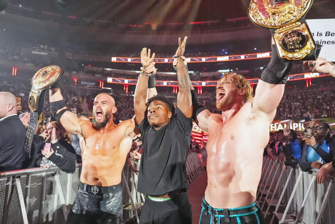 Austin Theory and Logan Paul raising IShowSpeed’s arms during a WWE RAW celebration at Madison Square Garden