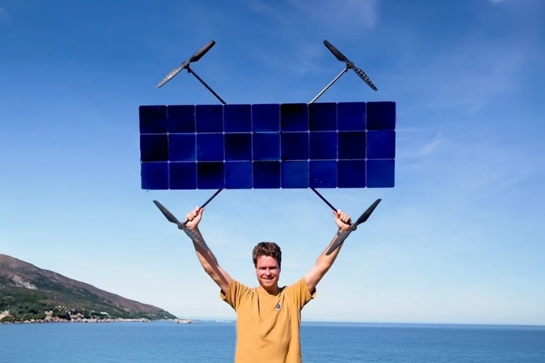 The Luke Bell solar drone hovering low above a grassy field during an endurance test flight.