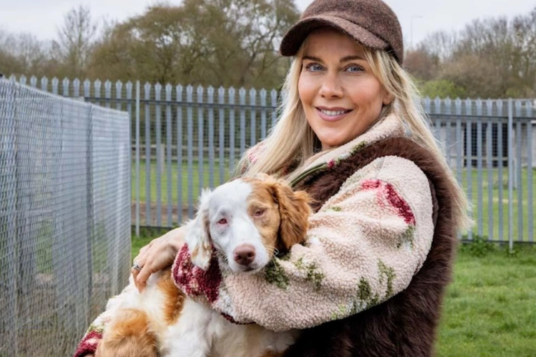 Kate Lawler holding a rescued dog after the RSPCA dog rescue involving more than 250 dogs in the UK.