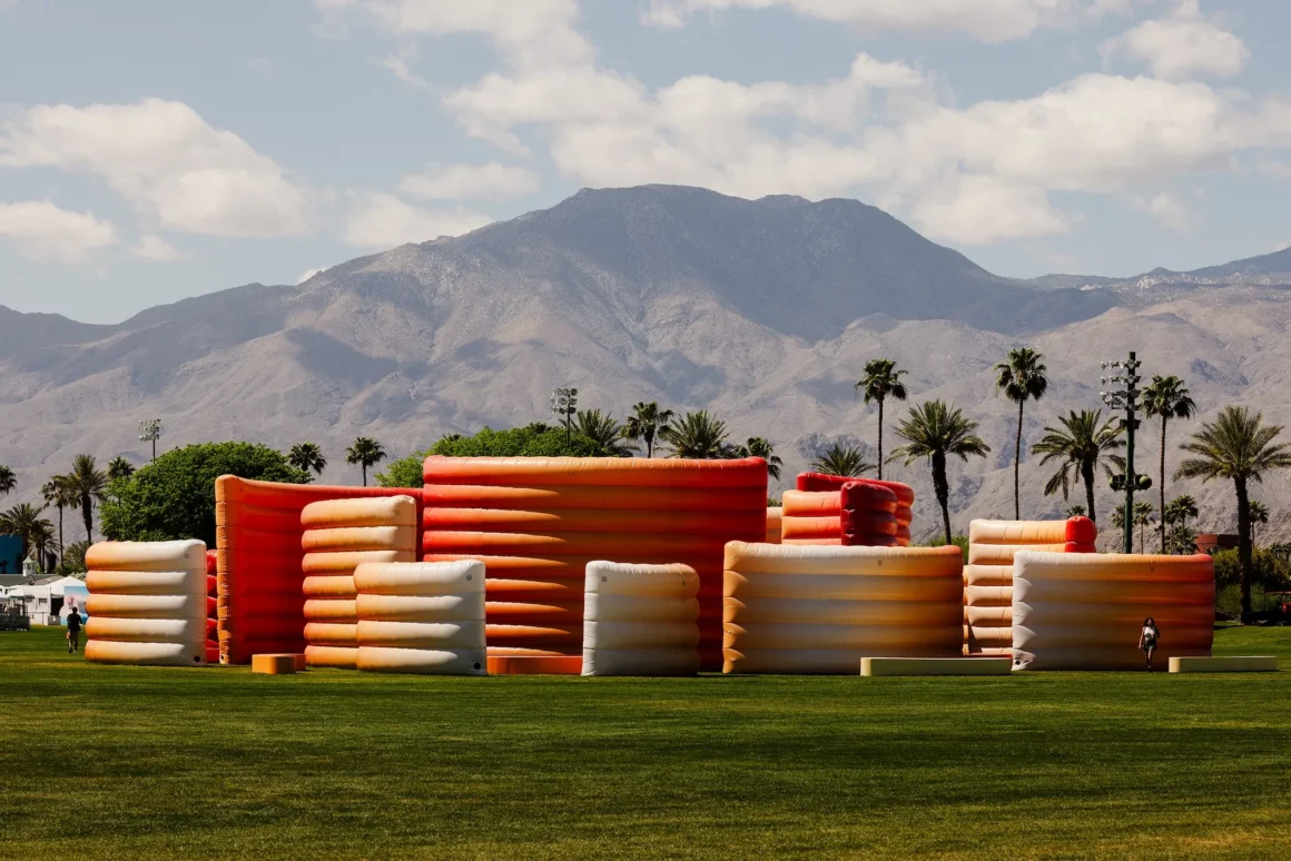 Wide view of the inflatable maze installation with mountains and palm trees in the background