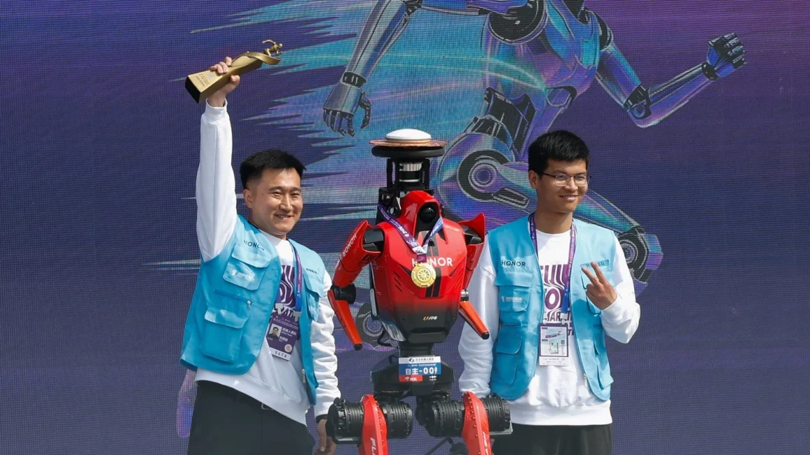 ngineers stand beside an Honor humanoid robot wearing a medal during an award moment after a half marathon event in Beijing, with a digital robot backdrop behind them.