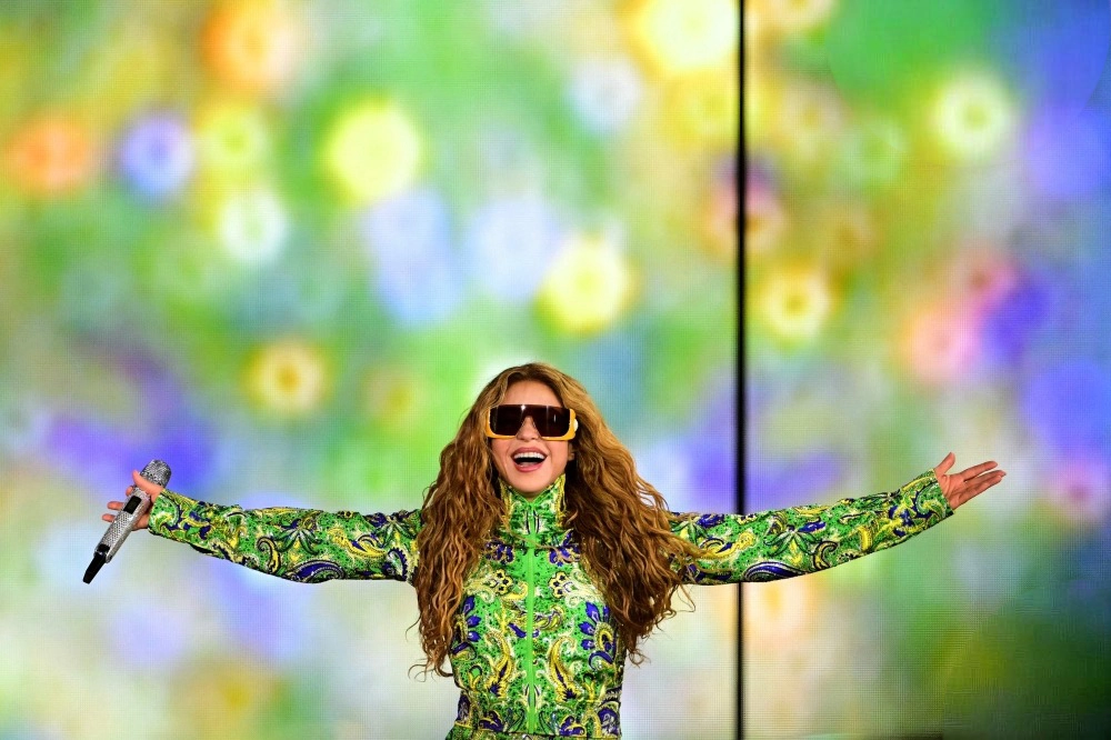 Shakira Copacabana concert 2026 shows Shakira performing onstage in a green outfit during the free Rio beach show