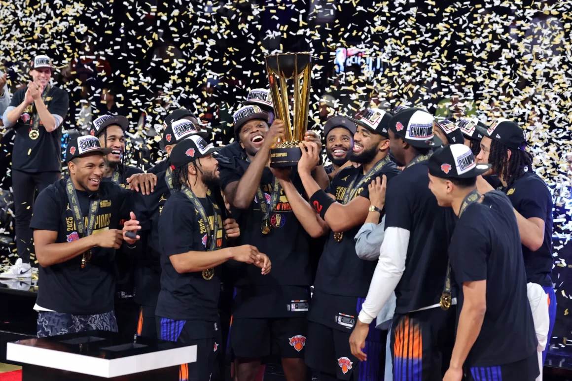 New York Knicks players celebrate with the NBA Championship Trophy after defeating the San Antonio Spurs in the 2026 NBA Finals.